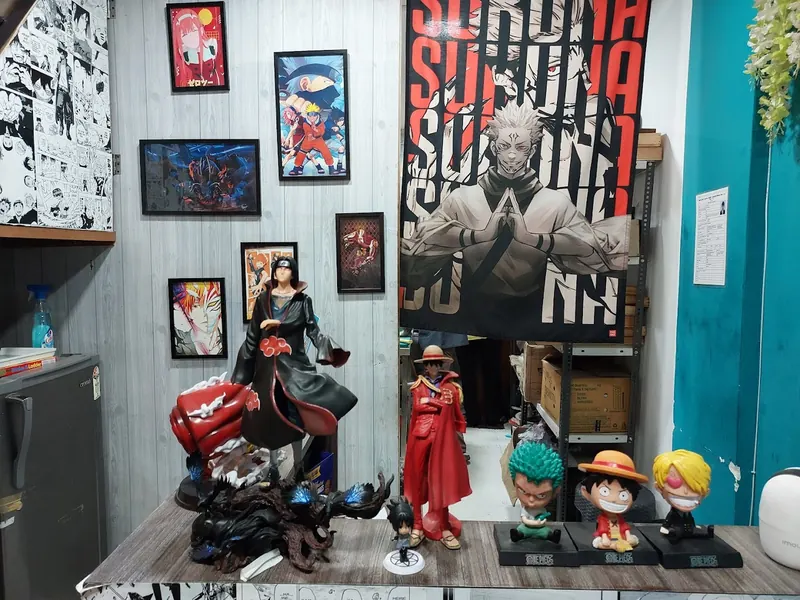 Figures and a Sukuna banner on the teal wall