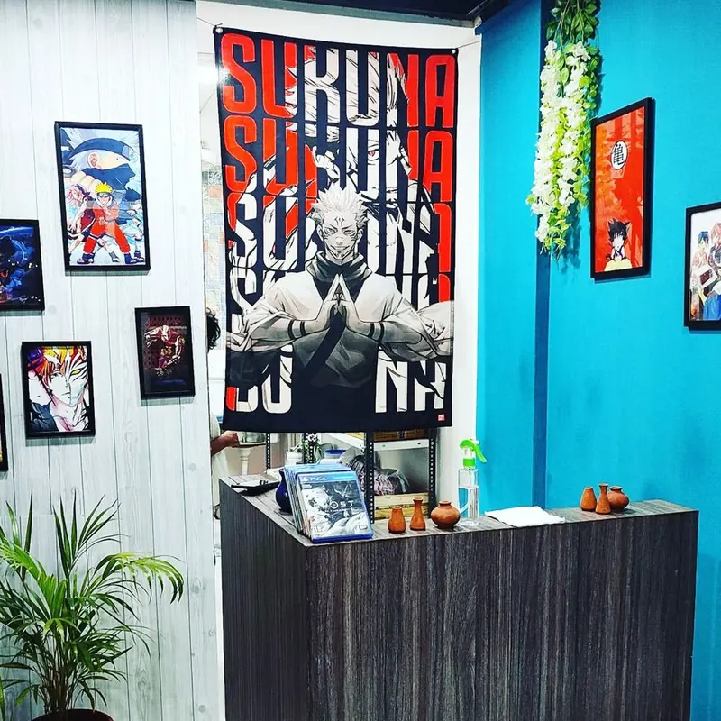 The counter under a Sukuna banner and framed anime posters