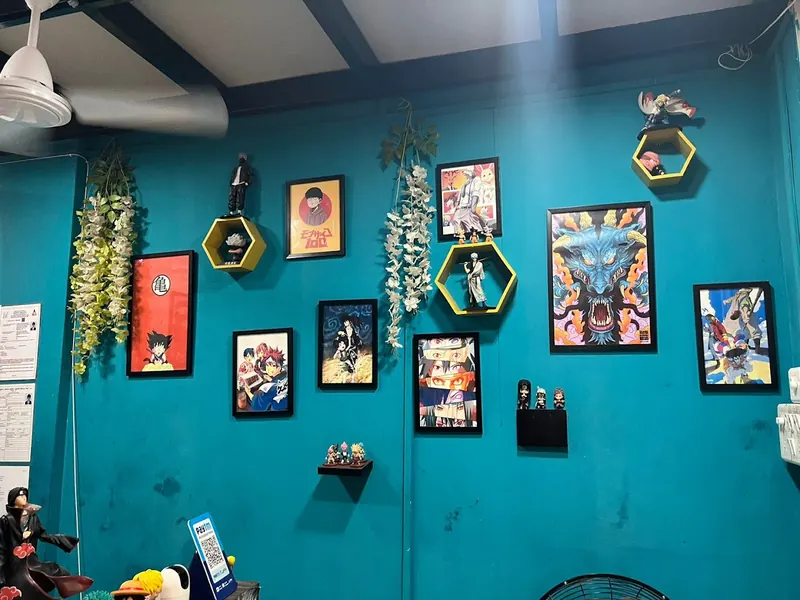 Teal wall covered with framed anime posters